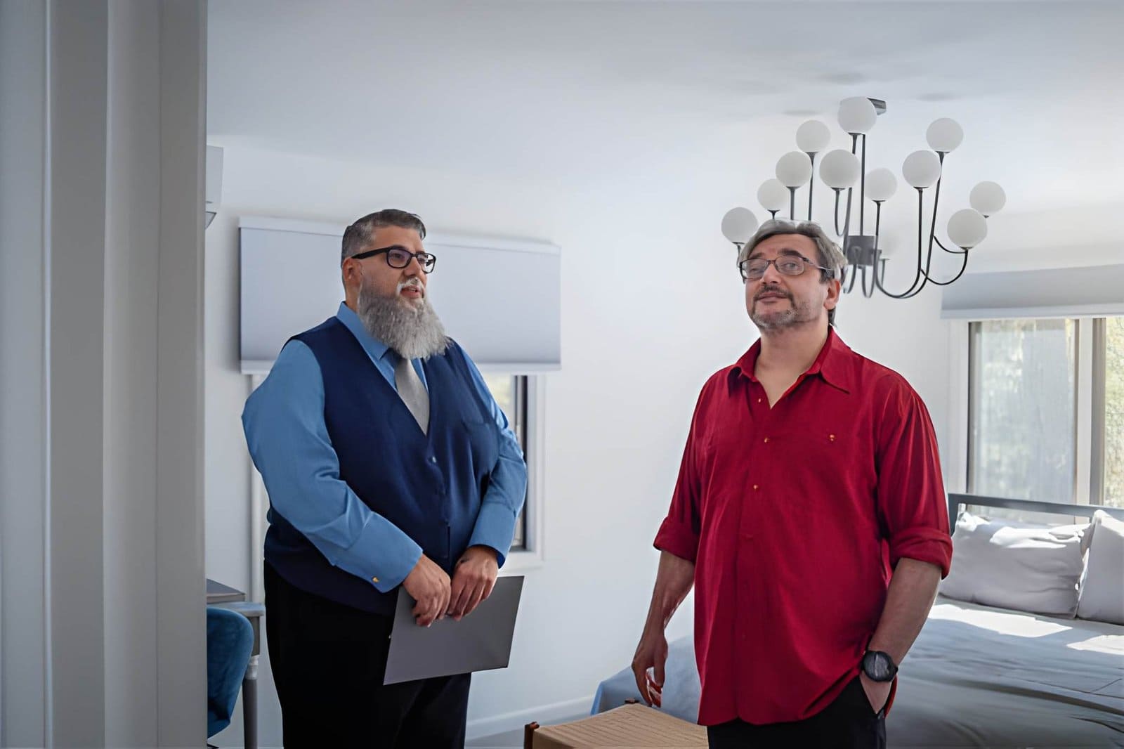 Property watch service near me—professionals discussing home inspection in modern bedroom.